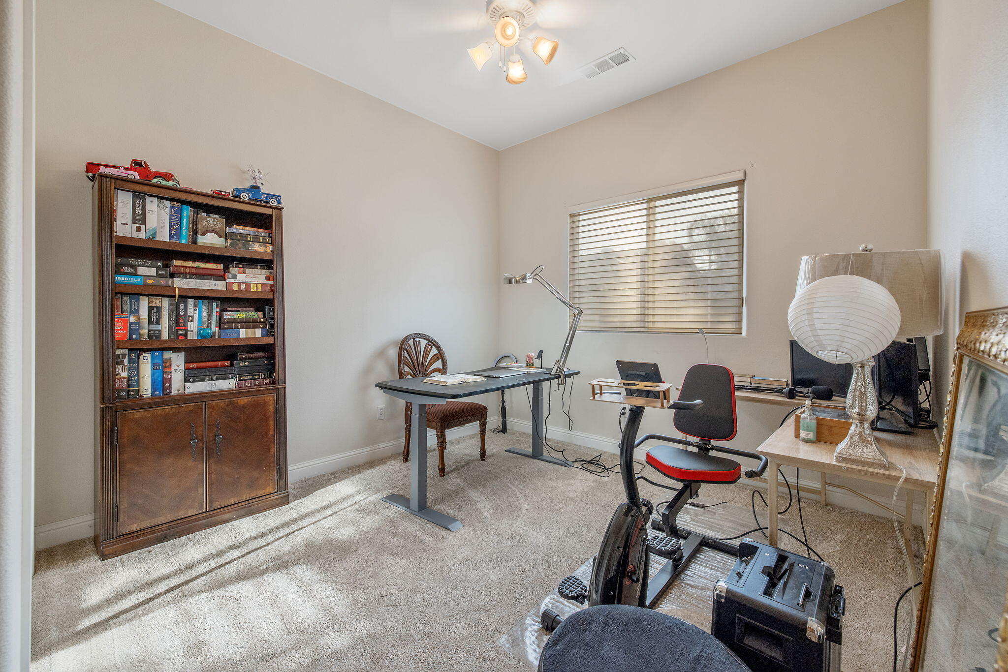729 St Thomas Court Exeter, CA 93221 - Photo 29 of 66 a work room with furniture and a book shelf