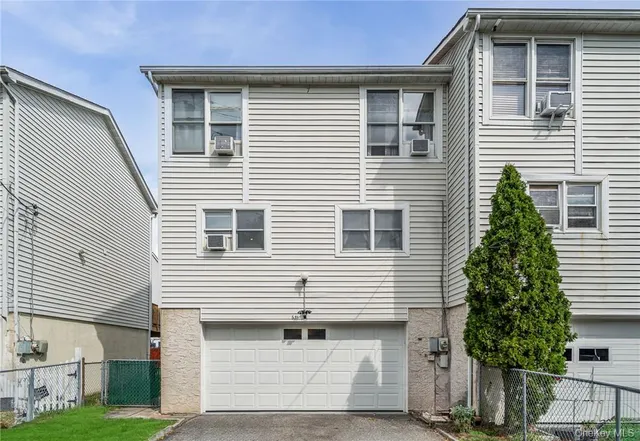 a front view of a house with a garage