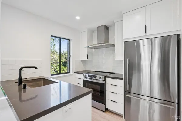 a kitchen with a refrigerator sink and stove