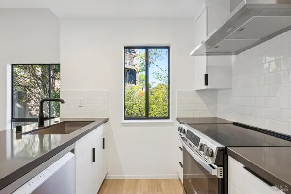a kitchen that has a sink and a stove in it