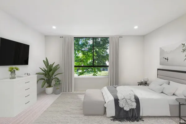 a bedroom with a large bed and a flat screen tv