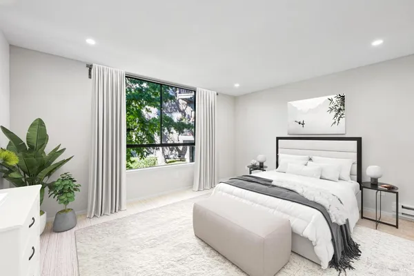 a bedroom with a large bed and a large window