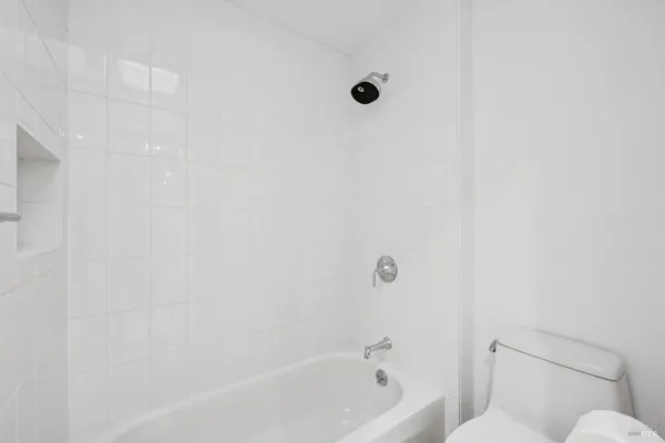 a bathroom with a bathtub and toilet