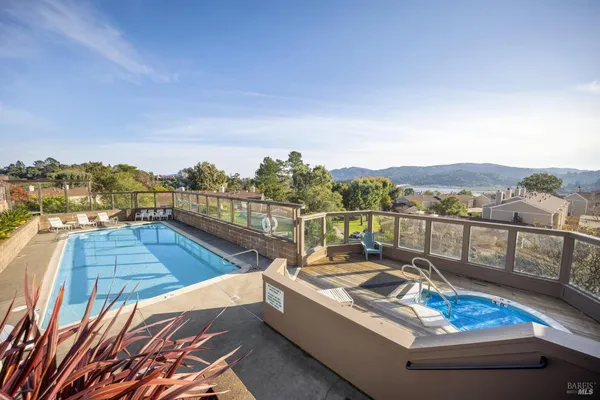 a view of a swimming pool with a lounge chair