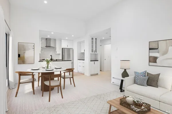 a living room with furniture a dining table and kitchen view
