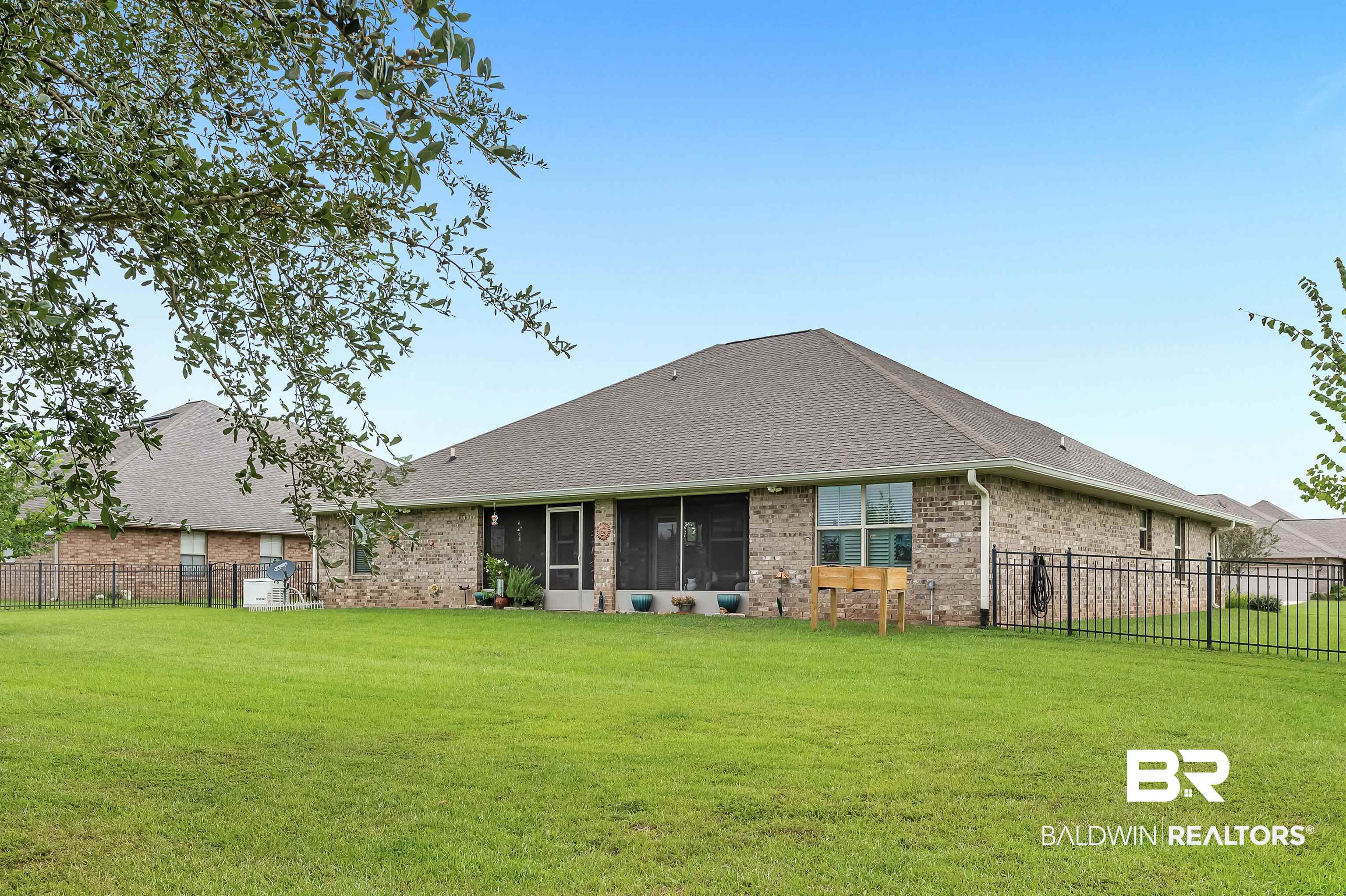 2033 Bourbon Street Foley, AL 36535 - Photo 13 of 57 Rear view of house featuring a sunroom and a yard