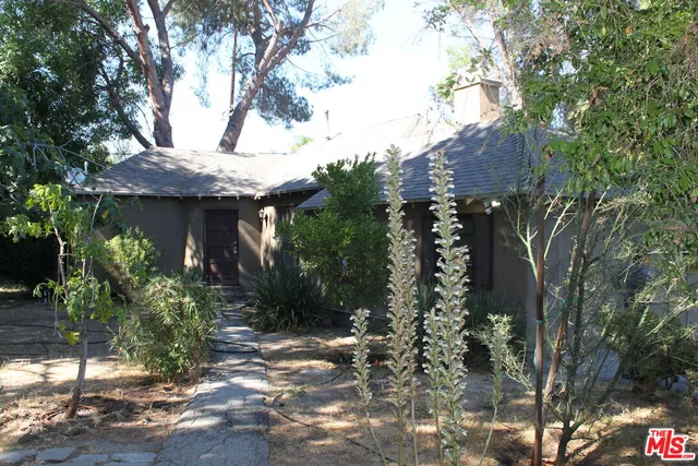 a view of a house with a tree