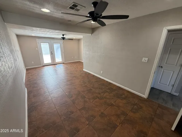 a view of a livingroom with a ceiling fan and window