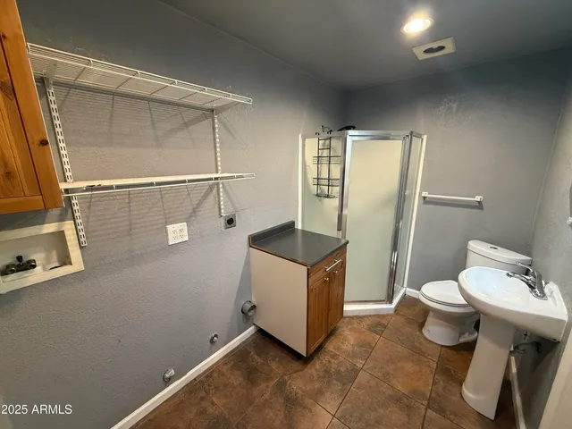 a bathroom with a sink mirror and toilet