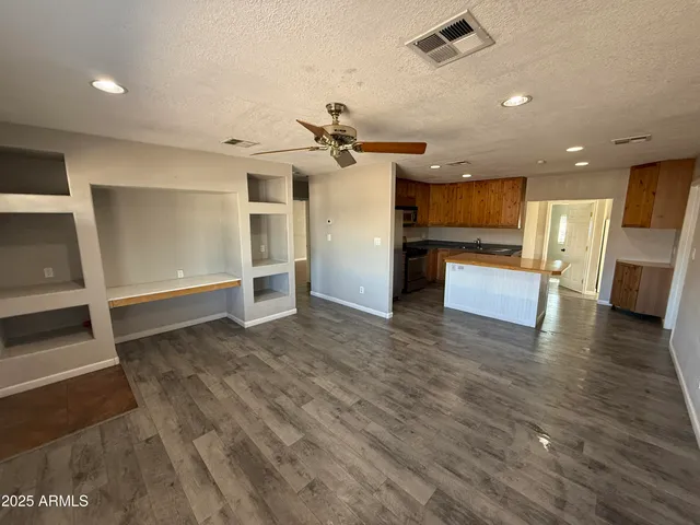 a view of a kitchen with a sink and a refrigerator
