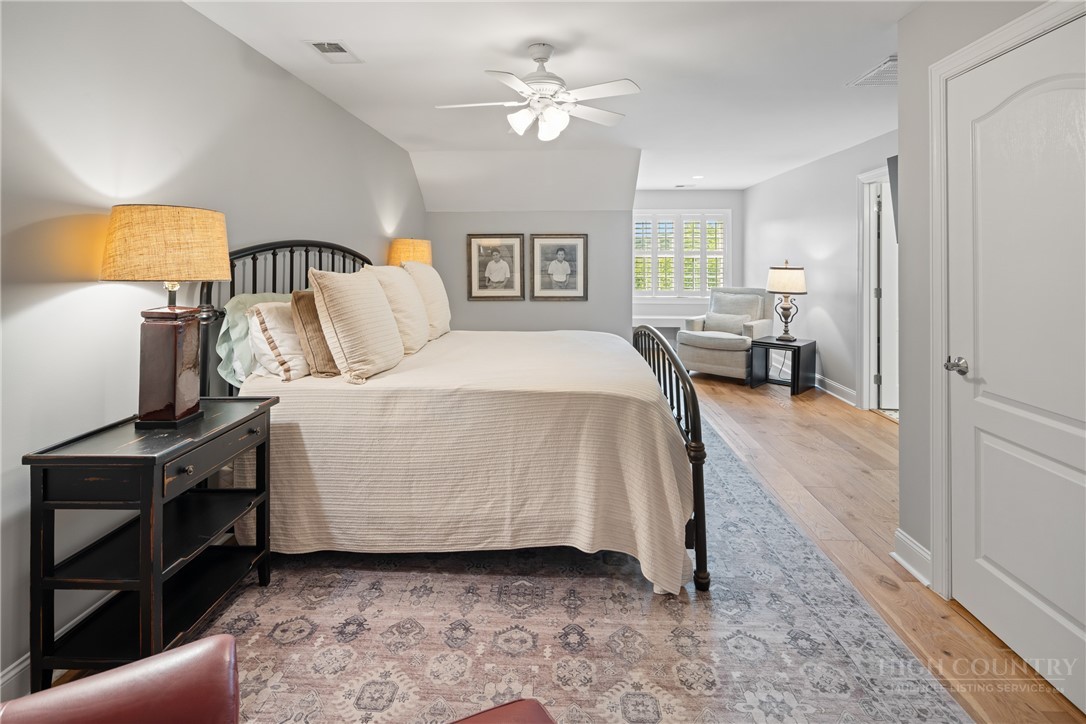 147 Riverside Park Court, Unit G2 Jefferson, NC 28640 - Photo 22 of 44 a bedroom with a bed and a chandelier