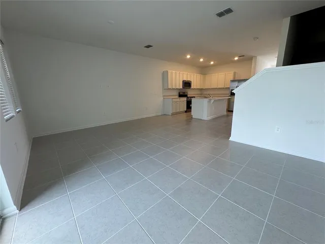 a view of a kitchen with a sink and a stove top oven