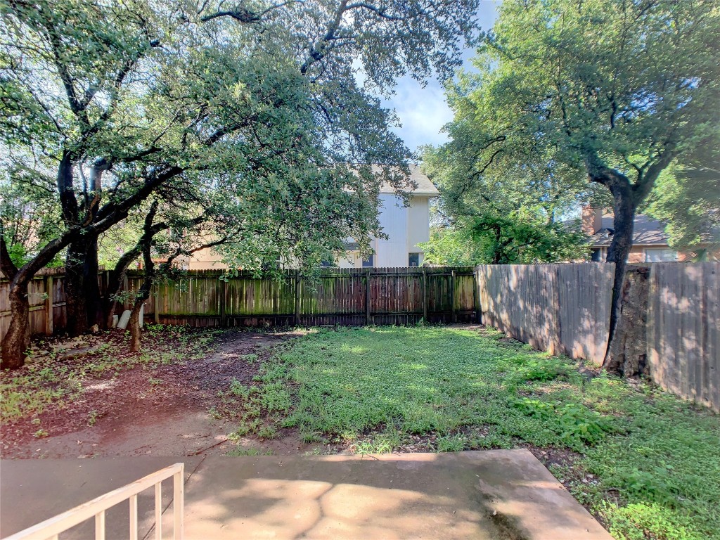 12705 Modena Trail Austin, TX 78729 - Photo 16 of 16 a backyard of a house with lots of green space