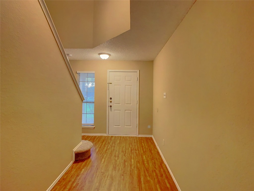 12705 Modena Trail Austin, TX 78729 - Photo 2 of 16 a view of a room with wooden floor and brick walls
