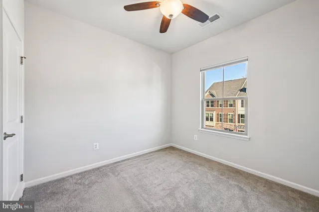 an empty room with ceiling fan