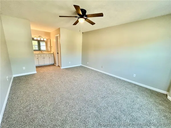 an empty room with a empty space and a ceiling fan