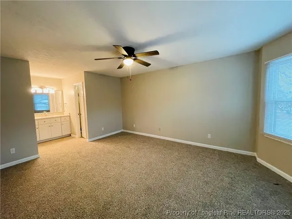 an empty room with a empty space and a ceiling fan