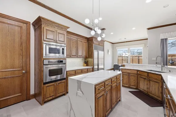 a kitchen with a stove oven and sink