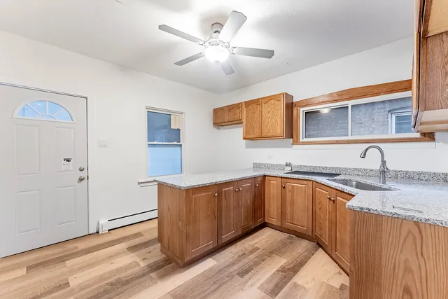 a kitchen with granite countertop cabinets stainless steel appliances and a fireplace