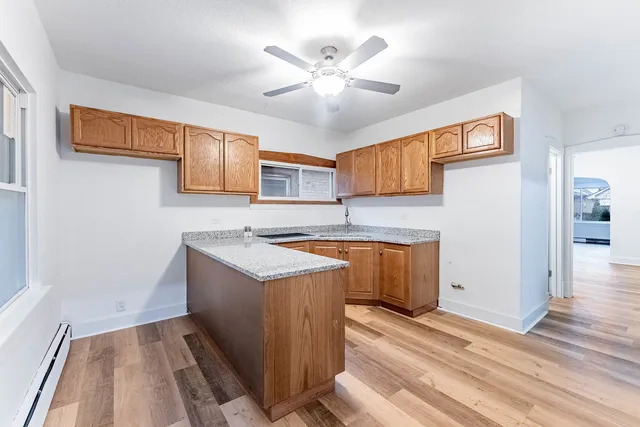 a view of a bedroom with wooden floor and a window