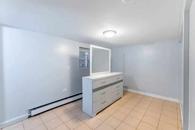 a view of a big house with a big yard plants and large trees
