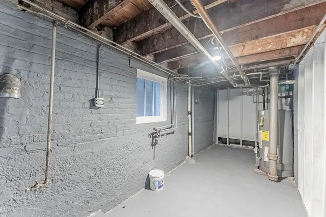 a view of a big house with a big yard plants and large trees