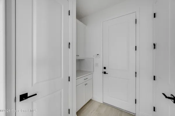 a kitchen with white cabinets stainless steel appliances and a sink