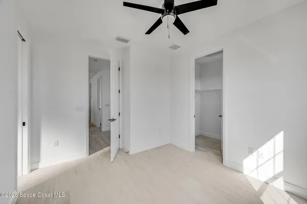 a view of a livingroom with a window and a ceiling fan