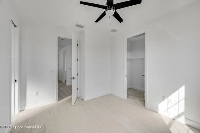 a view of a livingroom with a window and a ceiling fan