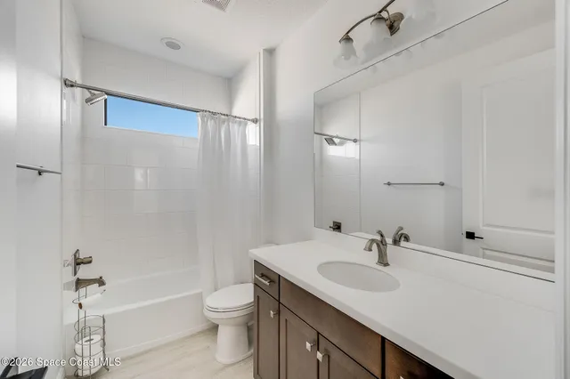 a view of a room with a sink and wooden floor
