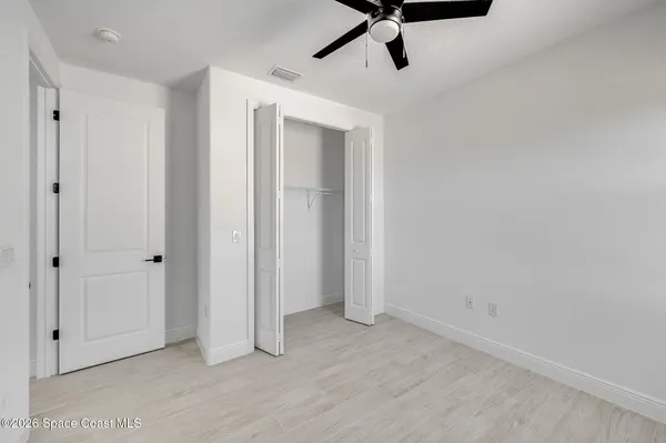 a view of a livingroom with a window and a ceiling fan