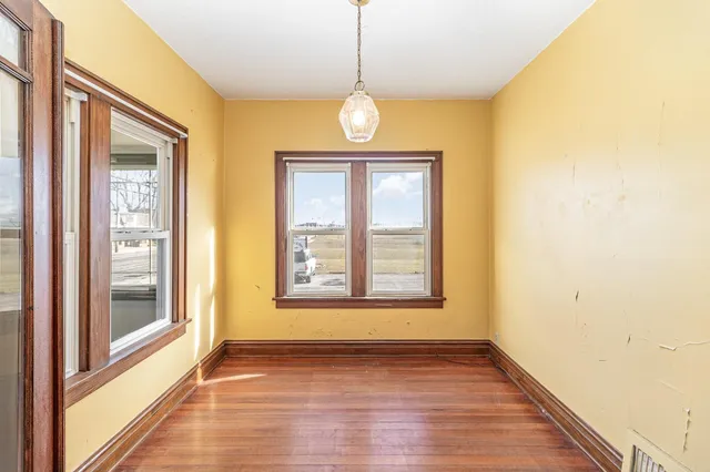 a kitchen with stainless steel appliances granite countertop wooden floors and white cabinets