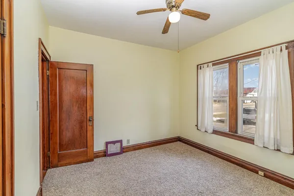 a view of a yard with snow on the road