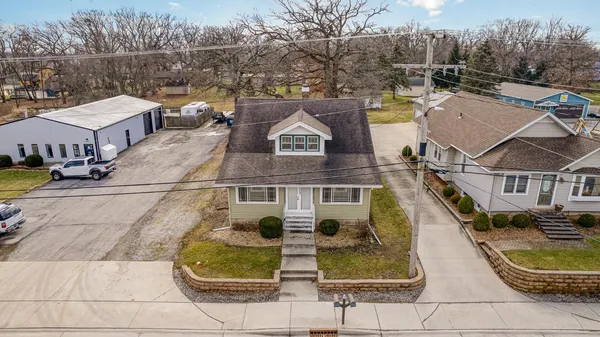 a aerial view of a house with swimming pool and sitting area