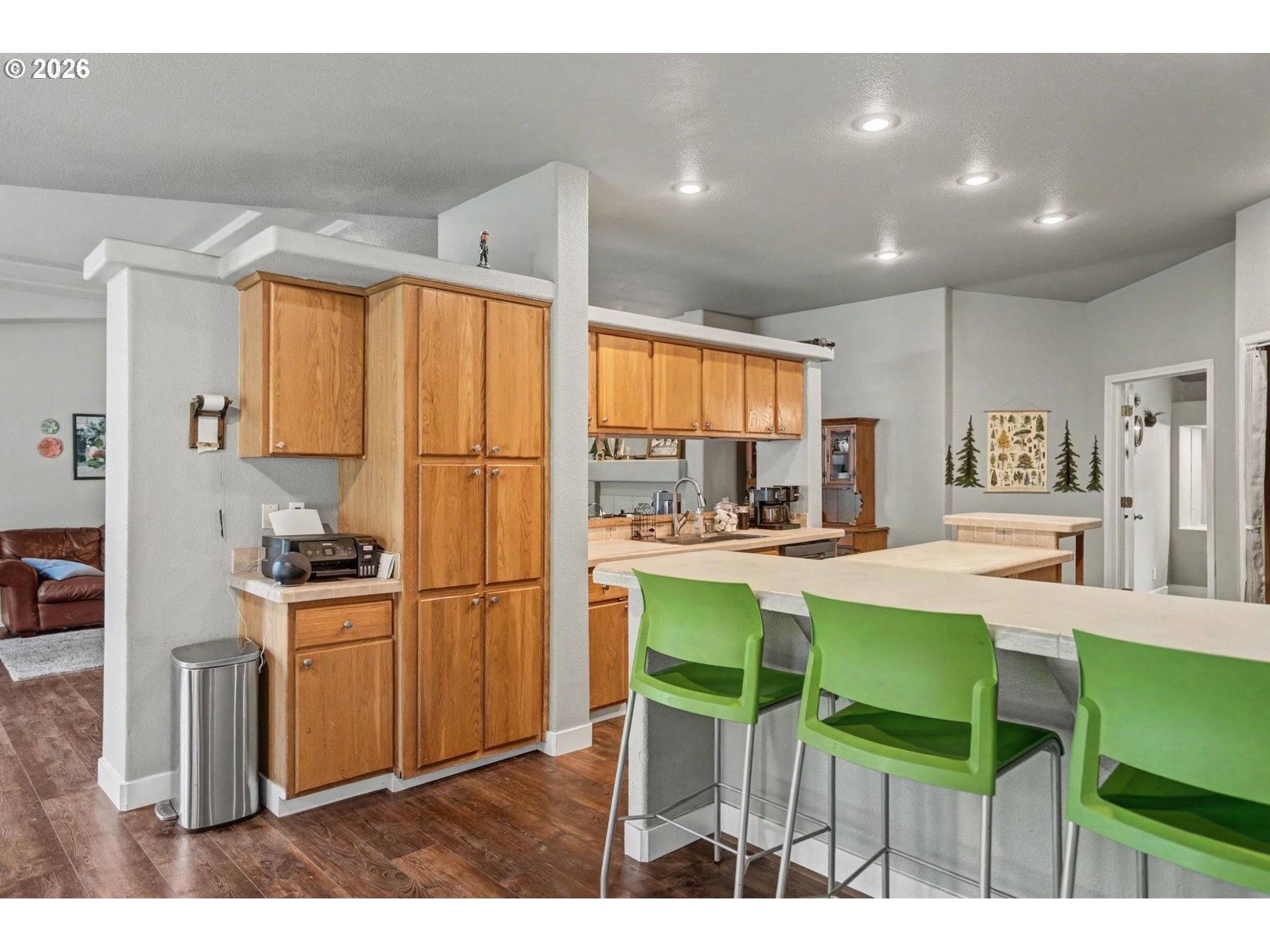 16310 Oakdale Road Dallas, OR 97338 - Photo 14 of 45 a kitchen with a table chairs refrigerator and cabinets