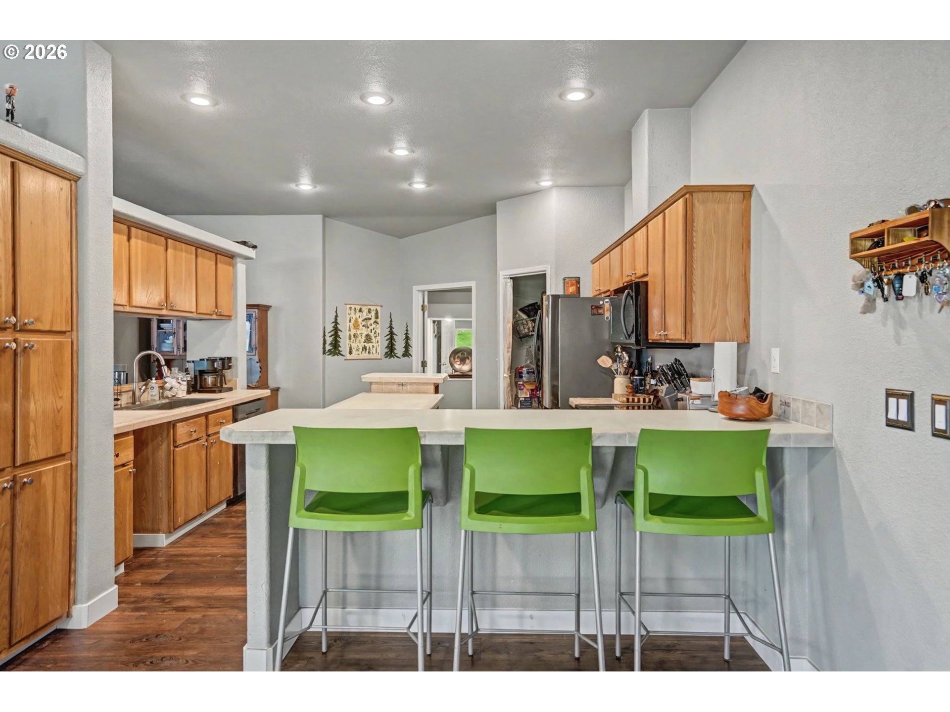 16310 Oakdale Road Dallas, OR 97338 - Photo 15 of 45 a kitchen with kitchen island dining table and chairs