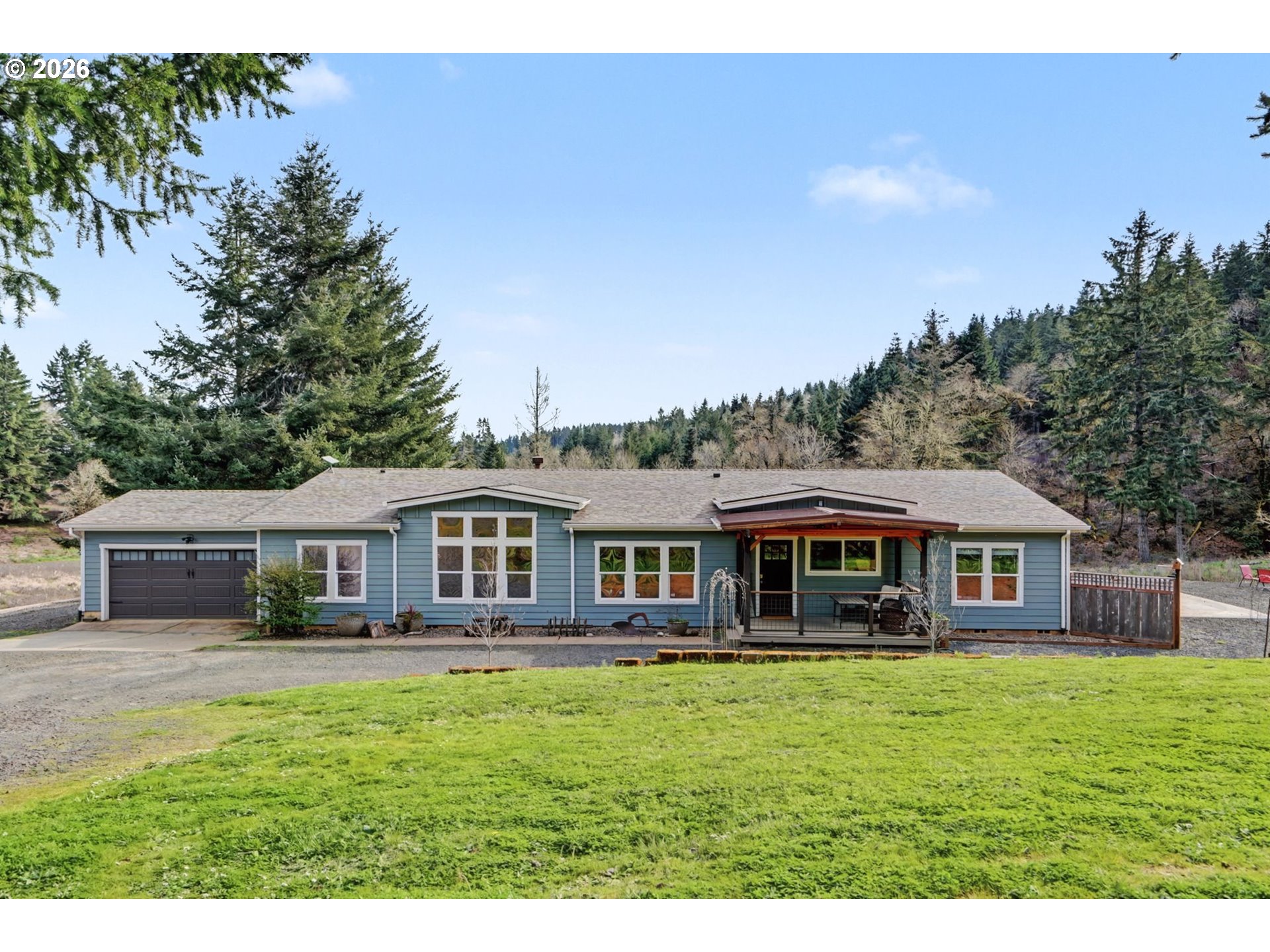 16310 Oakdale Road Dallas, OR 97338 - Photo 2 of 45 a front view of a house with a yard table and chairs