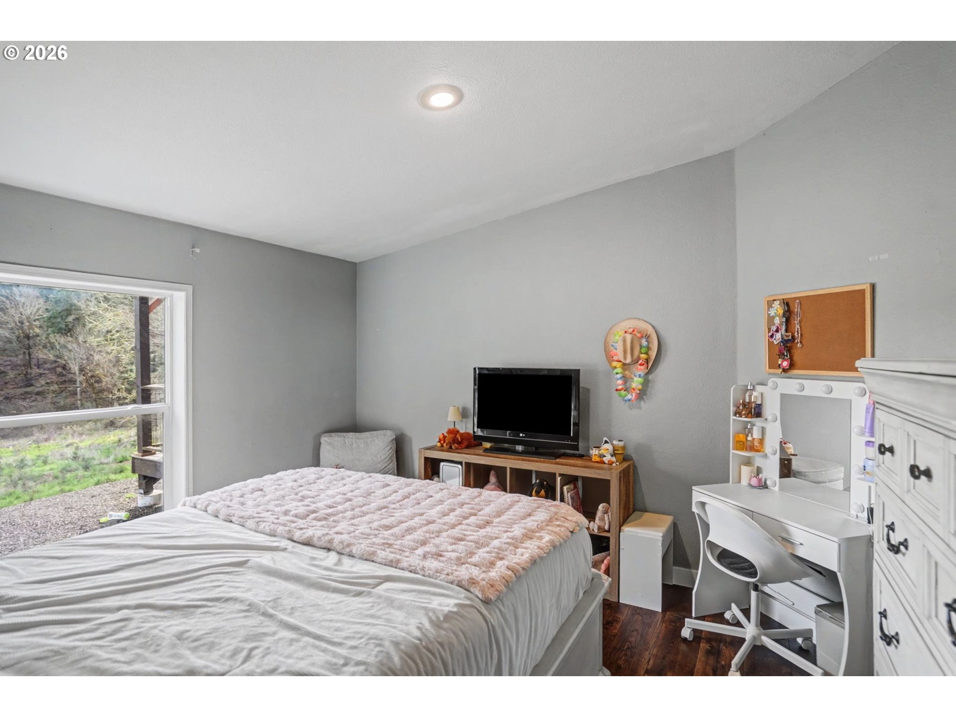 16310 Oakdale Road Dallas, OR 97338 - Photo 25 of 45 a bedroom with a bed and a flat screen tv
