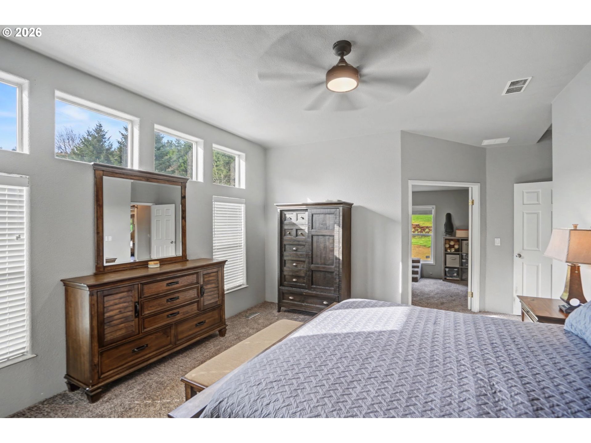16310 Oakdale Road Dallas, OR 97338 - Photo 10 of 45 a bedroom with a bed and a large mirror on the dresser