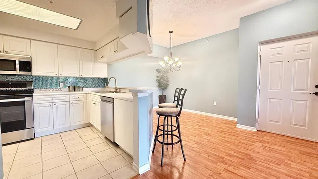 a kitchen with a sink cabinets and window