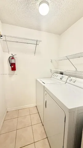 a utility room with a sink washer and dryer