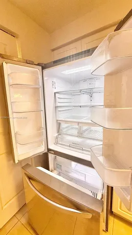 a view of a room with wooden floor and windows