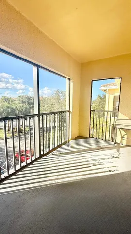 a view of a room with wooden floor and windows