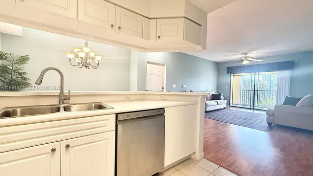 a kitchen with a sink cabinets and a large window