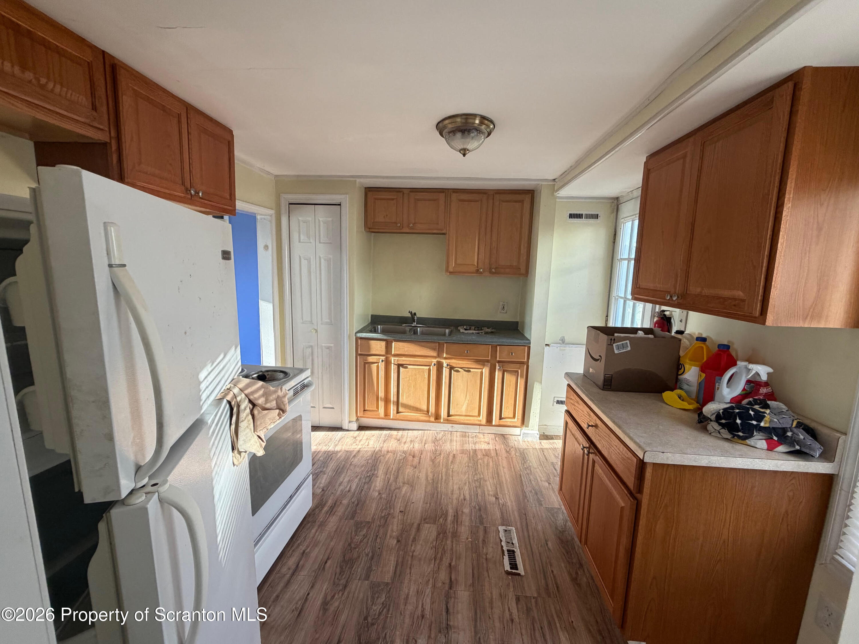 29 Maple Street Susquehanna, PA 18847 - Photo 3 of 9 a kitchen with granite countertop a sink stove and refrigerator