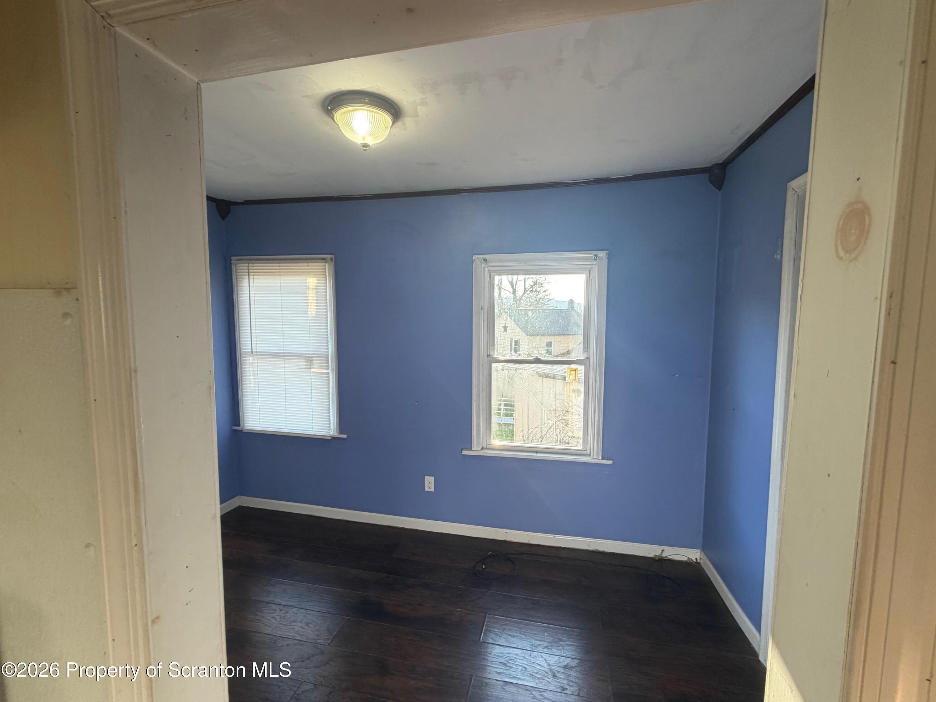29 Maple Street Susquehanna, PA 18847 - Photo 4 of 9 an empty room with wooden floor and windows