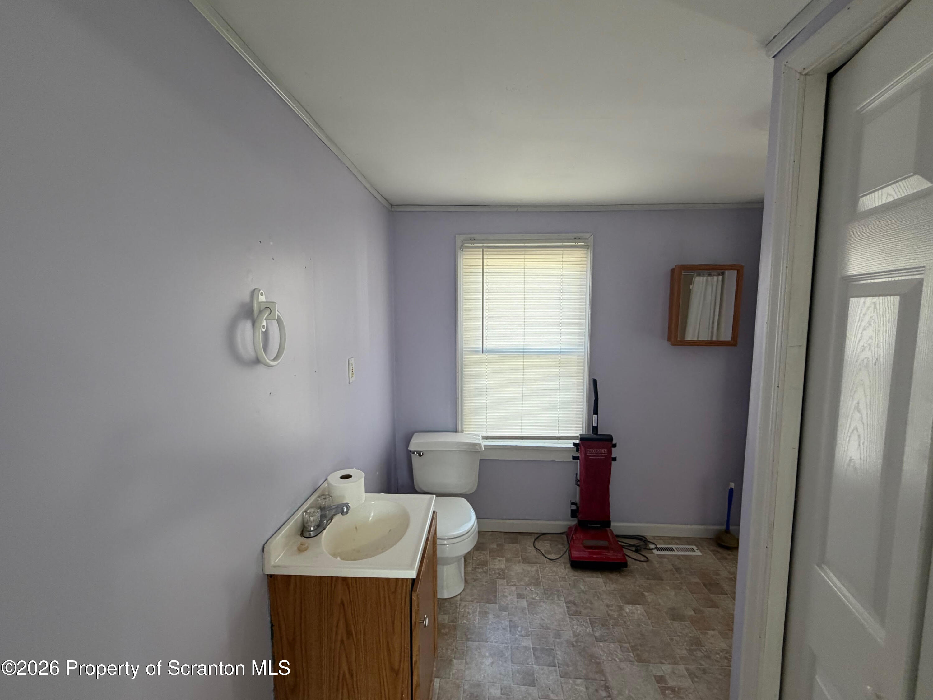 29 Maple Street Susquehanna, PA 18847 - Photo 7 of 9 a bathroom with a sink toilet and mirror