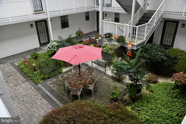 a view of a chairs and table on the garden