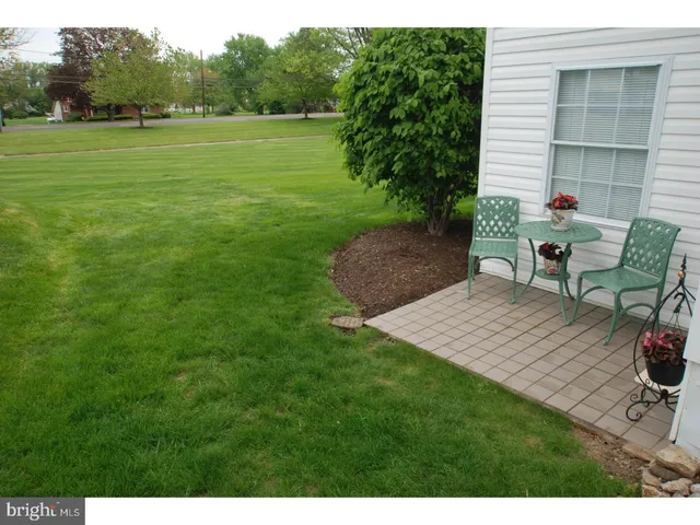 a front view of a house with a yard and a garden