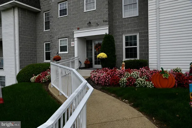a front view of house with yard and outdoor seating
